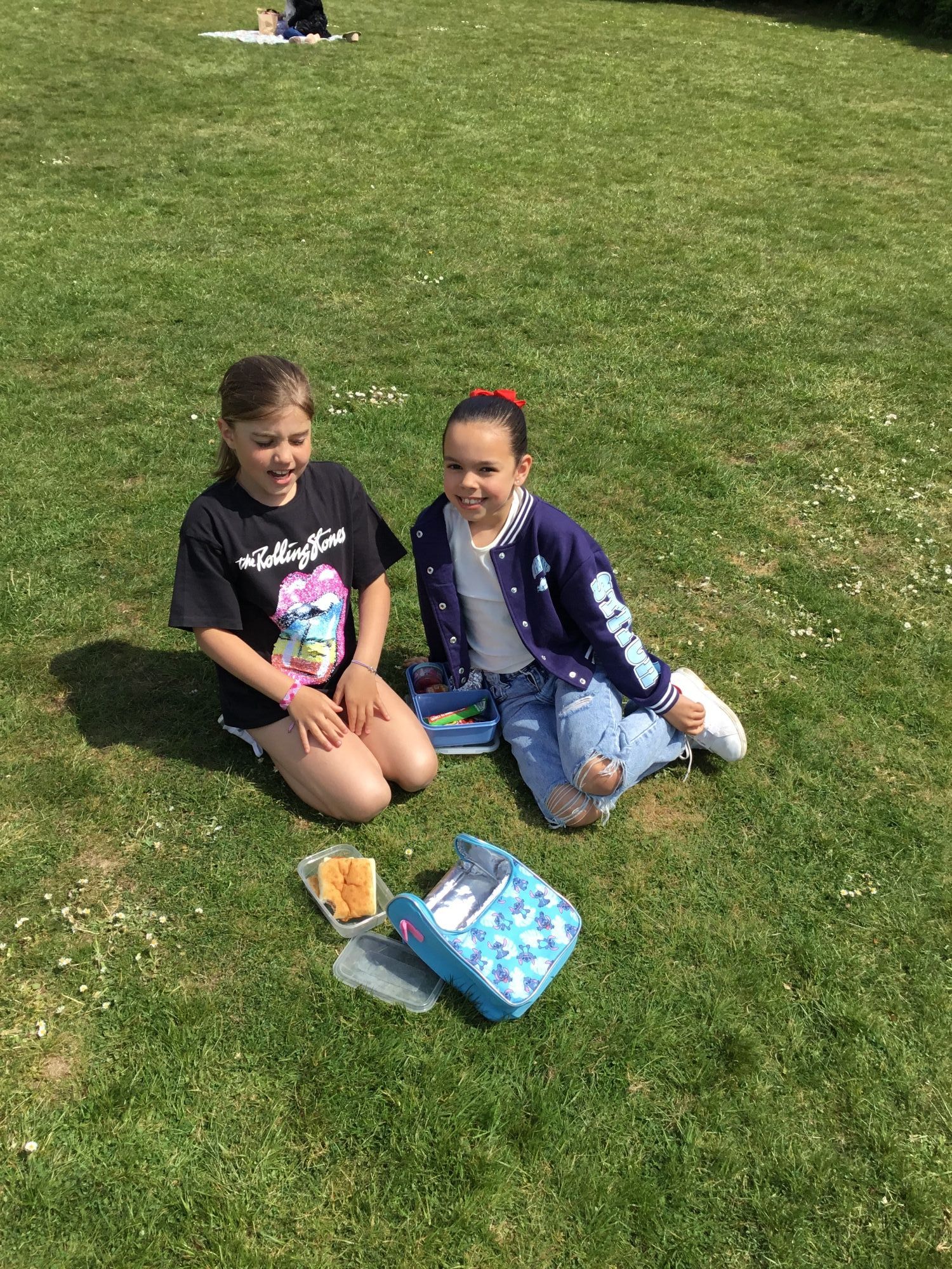 Children on the field enjoying their picnic.