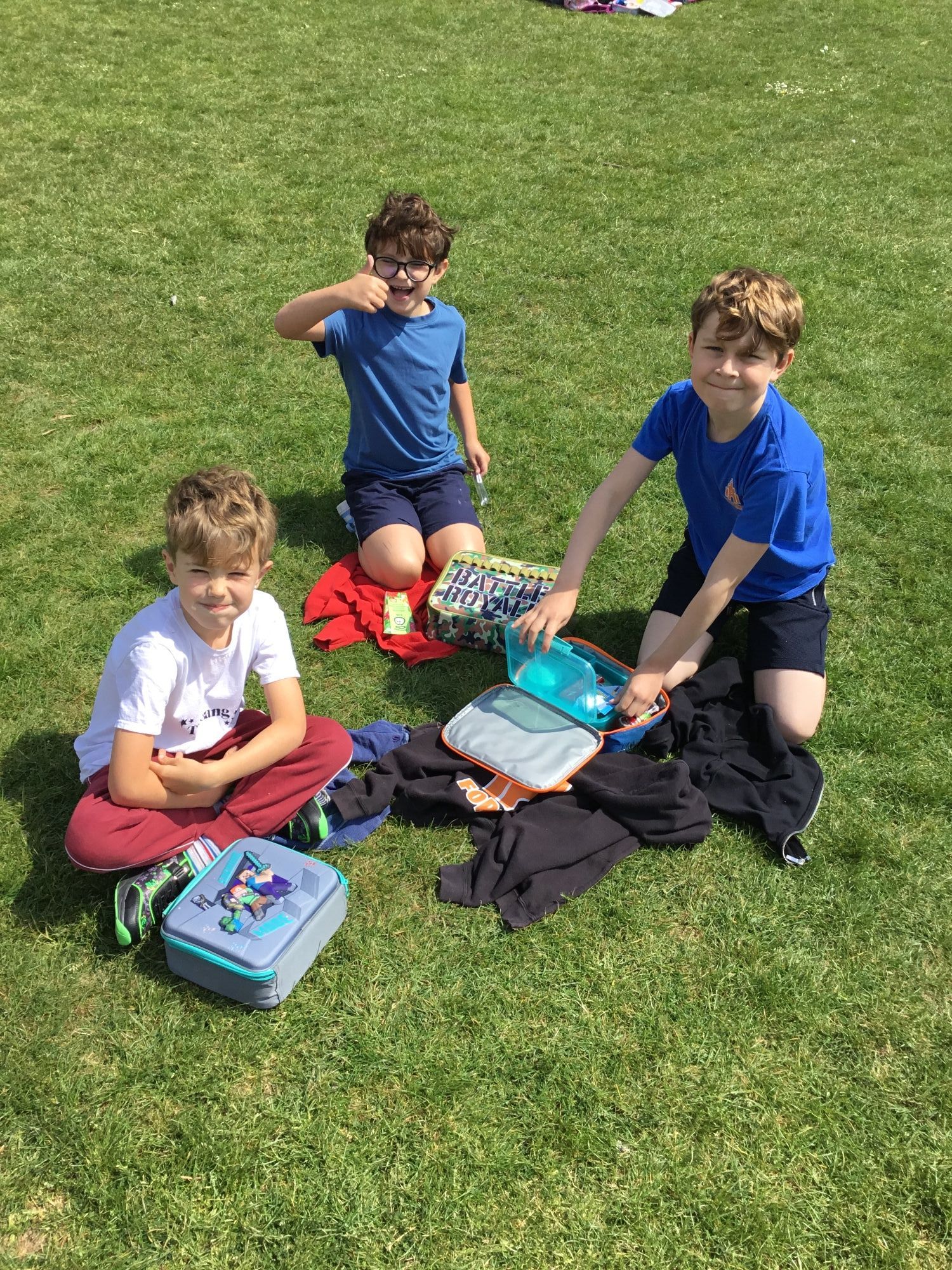 Children on the field enjoying their picnic.