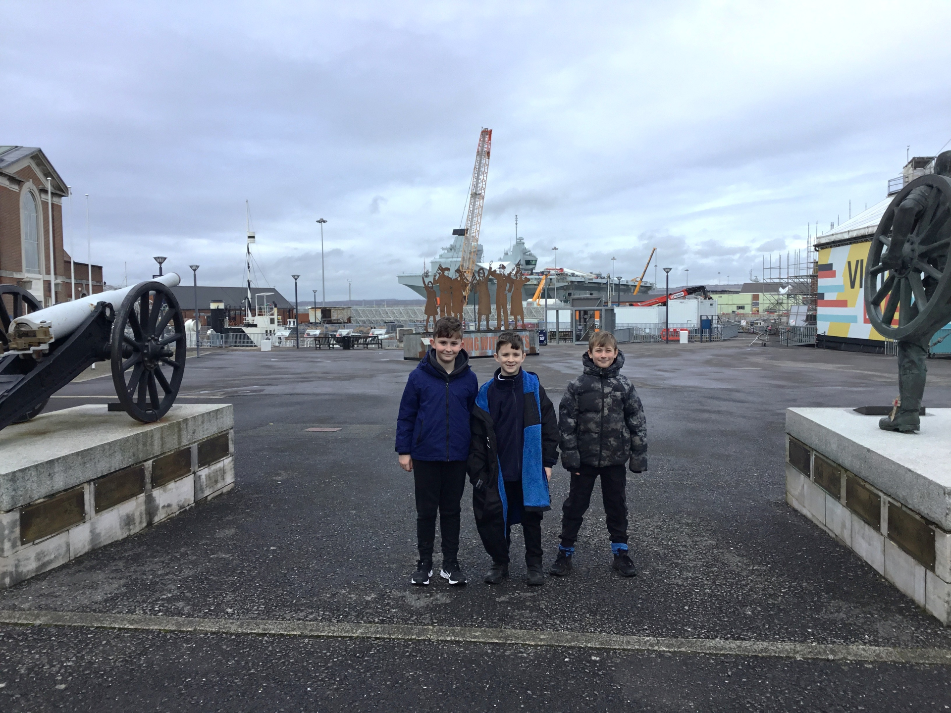 Children stood by a warship