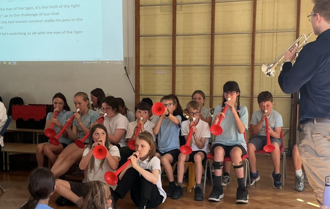 Children playing P-Buzz instruments