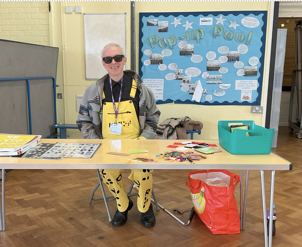 Clarke Reynolds sat at table smiling.