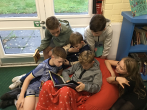 Boys sat together reading