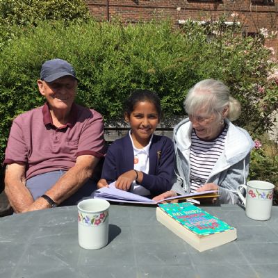 Child reading to resident