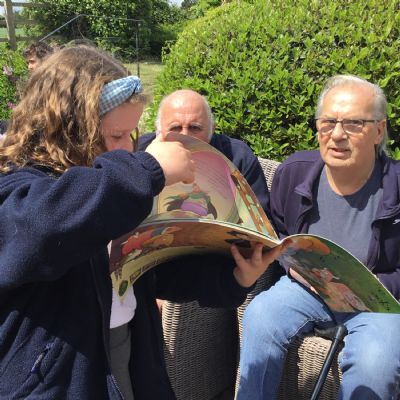 Child reading to resident