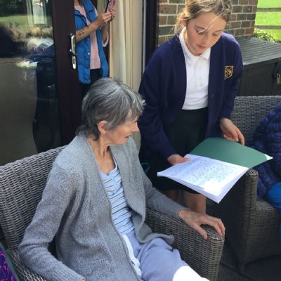Child reading to resident