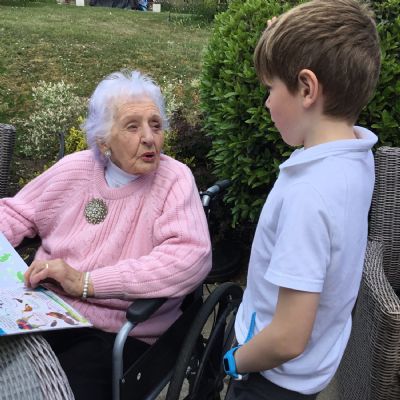 Child reading to resident